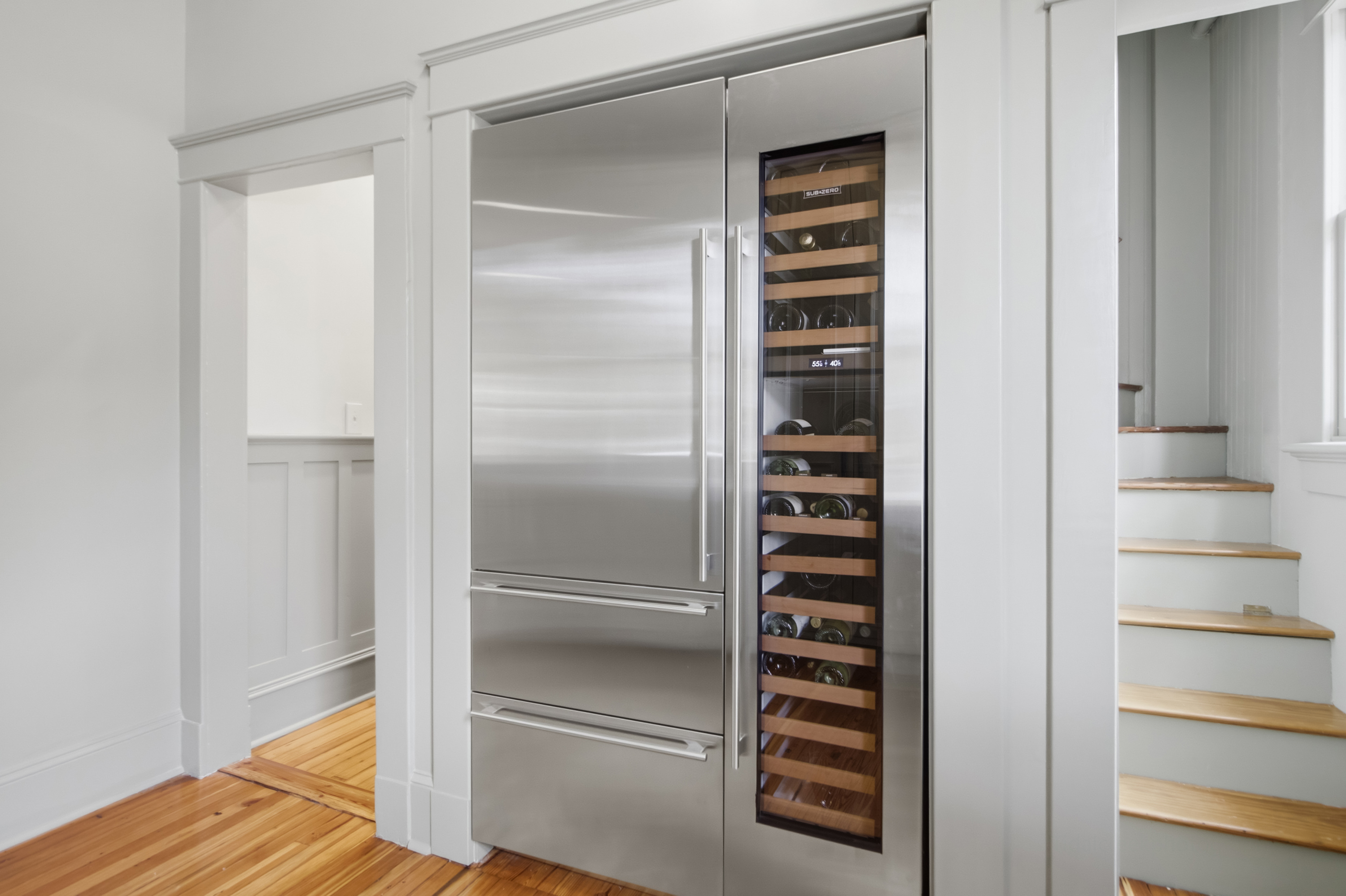 Butler's pantry with cabinetry and secondary refrigeration